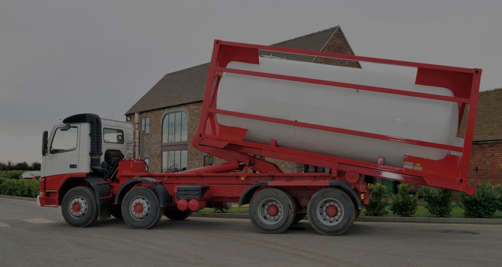 Holding tank being delivered on a hook-lift trailer