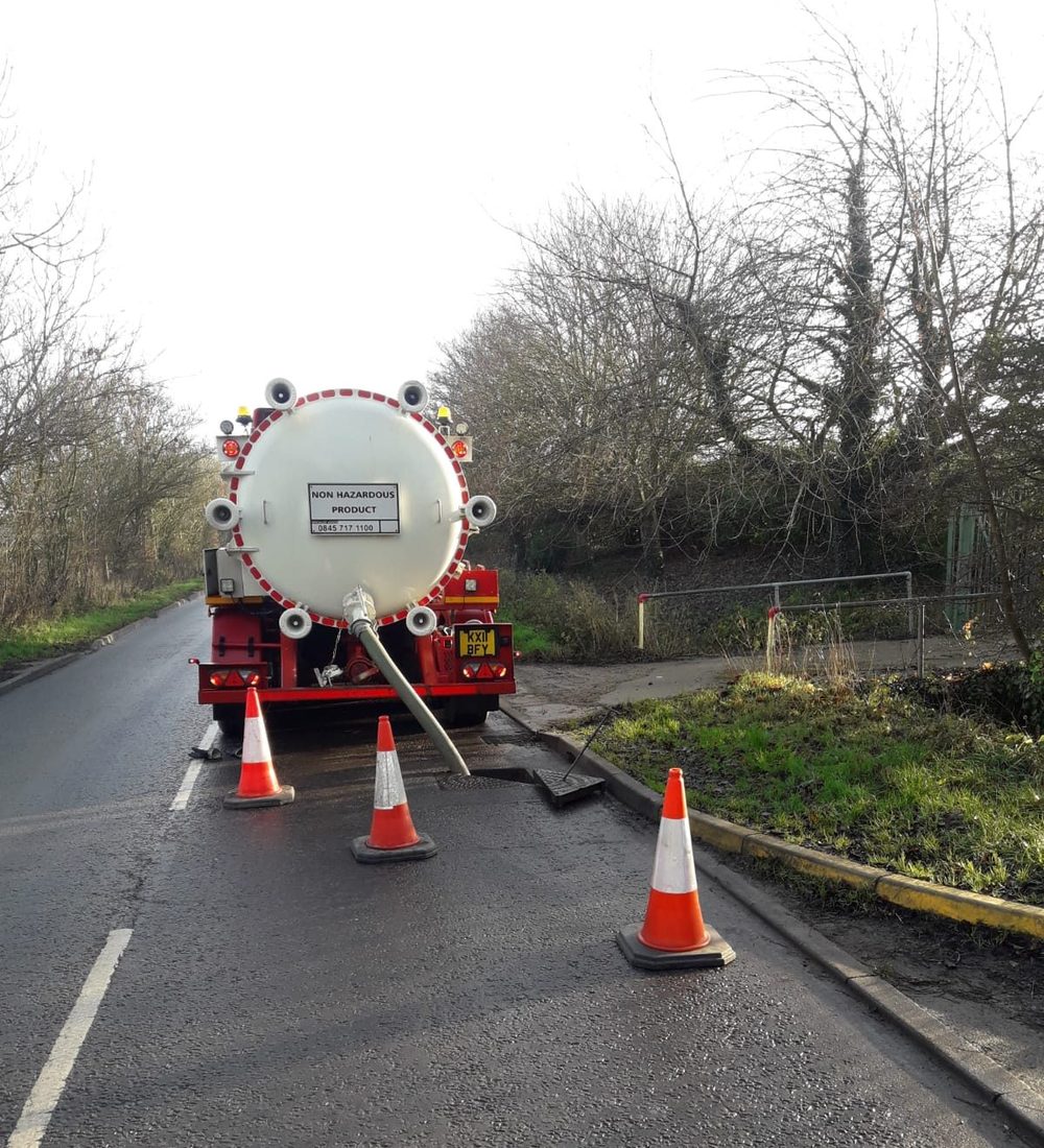 Tanker at the roadside with cones while working